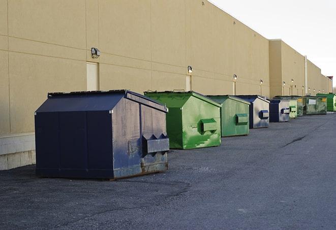 a group of dumpsters lined up along the street ready for use in a large-scale construction project in Columbia, CT